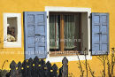 yellow wall blue shutters